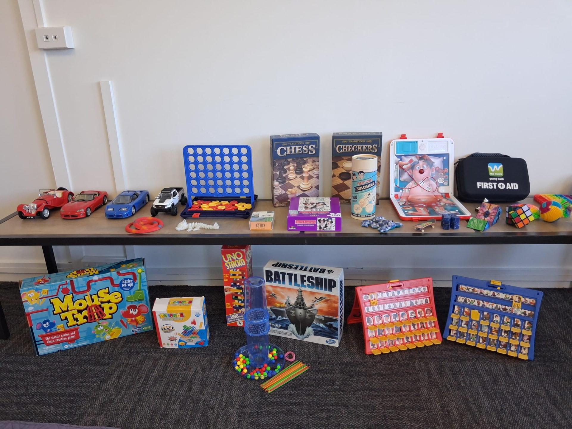 Shelf of board games, puzzles and fidget toys in the therapy room